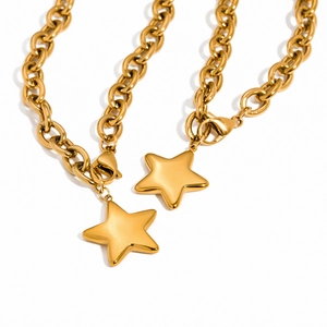 Polished gold stainless steel star pendant necklaces with thick curb chains on white background