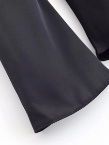 Close-up of high-quality black woven fabric stitching and texture on the sleeve cuff