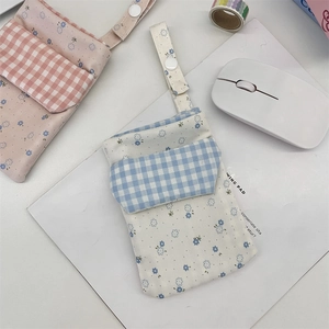 Detail view of floral canvas nurse pocket protectors with snap buttons and dual layers