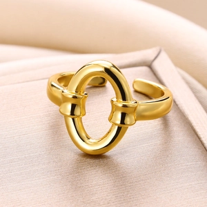 Detailed macro view of the gold-plated oval link ring with a polished metallic finish