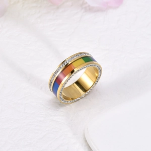 Close-up of golden rainbow ring with colorful enamel stripes and paved zircon stones