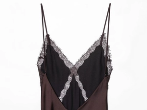 Close-up of deep brown satin midi dress with delicate black eyelash lace trim detail