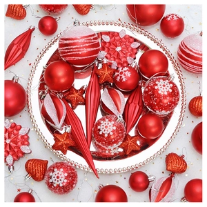 Macro detail of red Christmas ornaments set including stars and snowflakes on a silver tray