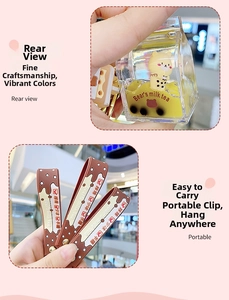 Close-up of a liquid-filled bear milk tea keychain with a brown silicone wristlet strap