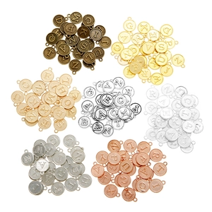 Detail of 26 alphabet charms in various metal finishes for DIY jewelry making
