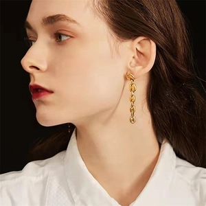 Elegant gold stainless steel coffee bean chain dangle earrings worn by a model