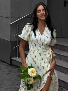 Detail of white cotton wrap dress with yellow tulip print and stylish puff sleeves