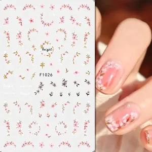 Detail view of F1026 floral nail stickers with pink watercolor flowers and green leaves