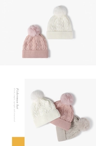 Detailed cable knit texture and large fluffy pom-poms on cozy winter beanies