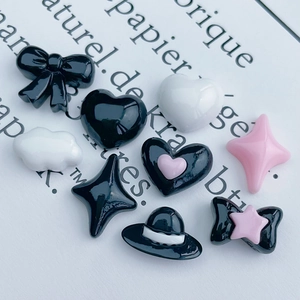 Glossy resin bow heart and star charms in black and pink for DIY nail art and crafts