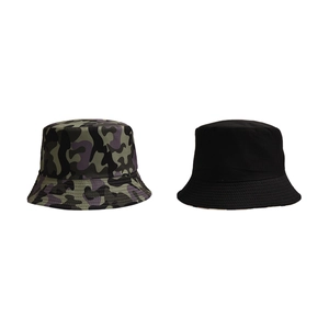 Flat lay set of two outdoor bucket hats featuring camouflage pattern and solid black style