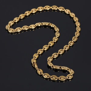 Close-up of 8mm gold coffee bean link chain with lobster clasp on reflective surface