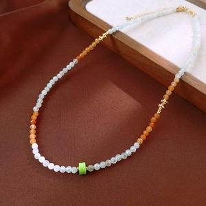 Macro detail of aquamarine and pearl beaded necklace with crystal accents and gold beads