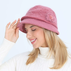 Detail of pink knitted bucket hat with flower accent and soft faux fur texture