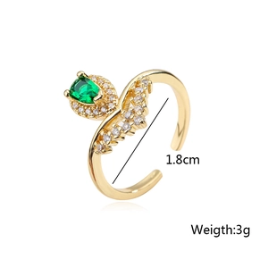 Macro shot of gold-plated ring with green pear-shaped zircon and white stones