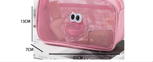 Pink mesh cosmetic bag with big eyes design, dimensions 21x13x7cm on magazine background