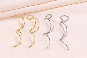 Detailed close-up of gold and silver S925 geometric spiral threader tassel earrings