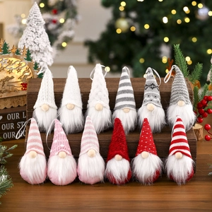 Close-up of 12 handmade knitted Christmas gnomes with striped hats on wood stand