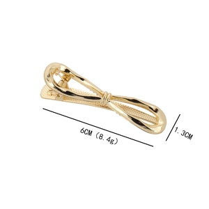 Irregular gold metal bow hair clip for women with dimensions of 6cm by 1.3cm