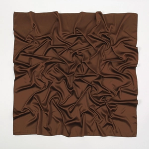 Detailed texture of brown matte faux silk square scarf showing soft drape and fabric grain