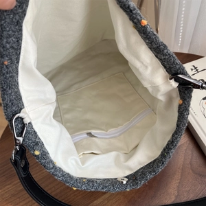Detailed interior of the wool tweed tote bag showing zipper pocket and magnetic closure