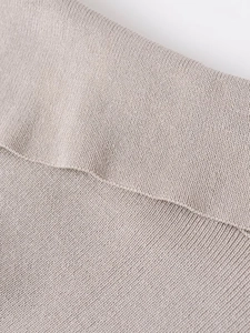 Close-up of oatmeal knit sweatshirt showing fine stitching and soft fabric texture