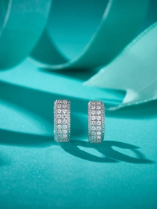 Macro shot of silver-tone hoop earrings with micro-pave sparkling moissanite diamonds