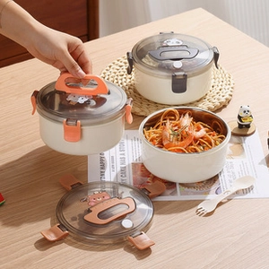 Detail of round stainless steel lunch box with off-white shell and dual-color handles