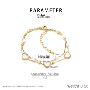 Detailed view of a gold stainless steel double layer bracelet with white hearts and pearls