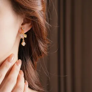 Elegant gold-plated flower tassel earrings with mother-of-pearl and clear zircon accents