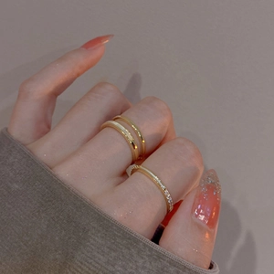 Close-up of gold-plated double-layer rings with zircon stones on a model hand