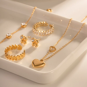 Macro view of 18K gold plated jewelry set with heart necklace and gemstone rings