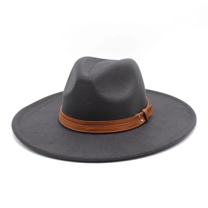 Detail of dark grey wide brim wool fedora hat with brown leather band and metal rivets