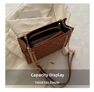 Macro view of large brown embossed tote bag interior with a secure zipper pocket