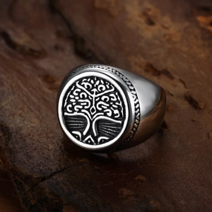 Macro shot of silver vintage Tree of Life ring with embossed details and antique finish