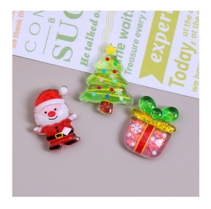 Detailed view of resin Santa, Christmas tree and gift box charms with glitter finish
