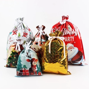 Detail view of colorful Christmas drawstring gift bags with various festive patterns