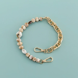 Detail of white marble beads and gold thick chain strap with lobster clasps