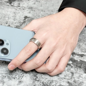 Man wearing 8mm matte brushed titanium steel ring holding a smartphone