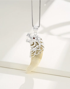 Detailed S925 sterling silver lion head pendant with red gemstone eyes and bone-like claw