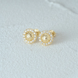 Macro shot of S925 sterling silver stamp on the gold-plated round zircon stud earring