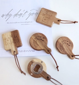 Detail of wooden magnetic bottle opener with leather strap and animal engraving