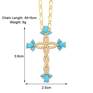 Detailed view of gold cross pendant with blue turquoise and zircon, 3.6cm x 2.5cm size