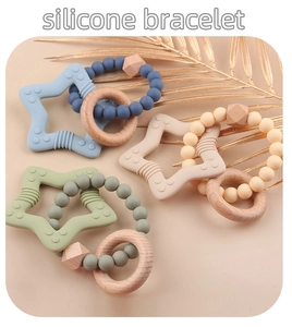 Close-up of star-shaped silicone teether bracelet with wood rings in Morandi tones