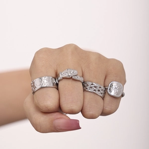 Silver texture stainless steel ring set featuring smiley face and snake motifs on model