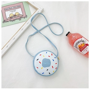 Detailed top view of light blue donut shaped girl crossbody bag on white textured background