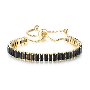 Detail of gold tennis bracelet with rectangular black zircons and adjustable slider clasp