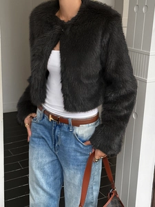 Deep gray plush short cardigan jacket styled with jeans and a leather belt in a studio