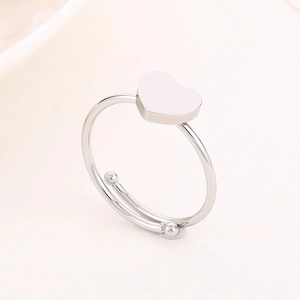Macro shot of silver adjustable open heart ring with dual metal beads on polished band