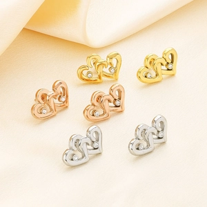 Detailed view of interconnected heart earrings in gold, rose gold, and silver finishes